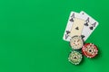 Poker chips stack and playing cards - two aces on green table Royalty Free Stock Photo