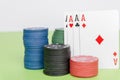 poker chips stack with two cards an ACE. On the green table on white background Royalty Free Stock Photo