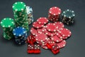 Poker chips stacked on black background and 5 red dice Royalty Free Stock Photo