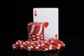 Poker chips stacked and cards to play on a black background Royalty Free Stock Photo