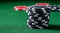 Poker chips stacked on a vibrant green poker table Royalty Free Stock Photo