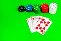 Poker chips in stacks and a royal flush on a green table Royalty Free Stock Photo