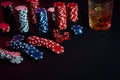 Poker chips and wine glass of cognac on dark table. Gambling Royalty Free Stock Photo