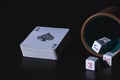 Poker cup with dice and deck of cards to play poker