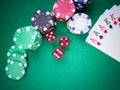 Poker full house of aces and kings on green table with red cubes and poker chips Royalty Free Stock Photo