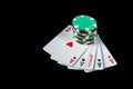 Poker game with five of kind combination. Chips and cards on the black table. Maximum winnings in poker