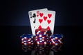 Poker game with one pairs combination. Chips and cards on dark table. Successful and win Royalty Free Stock Photo