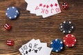 Poker game on a wooden table, cards with chips and dice of poker