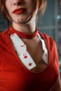 poker girl in a dress with a neckline in which poker cards look seductively on a woman& x27;s chest. poker gambling Royalty Free Stock Photo