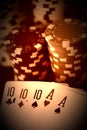 Poker hand with full house cards and jeton chips in close up on black backgrund - made like an old photo