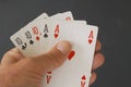 Poker hand full house with three cards of ten and two aces - close up on black background Royalty Free Stock Photo