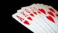 Poker hand of Royal Flush of hearts isolated on black background. Royalty Free Stock Photo