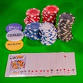 Playing cards, poker chips and buttons on a green felt table Royalty Free Stock Photo
