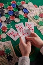 A poker player in a casino, a combination of straight flush cards, a lot of money and chips. Vertical frame Royalty Free Stock Photo