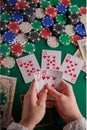 A poker player in a casino, a combination of straight flush cards, a lot of money and chips. Vertical frame Royalty Free Stock Photo