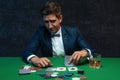 Poker player is frustrated and emotional over loosing and finding it hard to contain his emotions