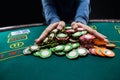 Poker player going all in pushing his chips forward