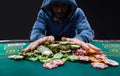 Poker player going all in pushing his chips forward