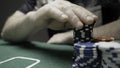 Poker players at a green table with chips and cards. Action. Concept of risk and excitement, playing poker at casino.