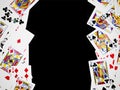 Poker playing cards are arranged on both side of the black background. Royalty Free Stock Photo