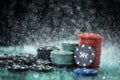 Poker playing chips on a green table and black background under the water drops. Online gambling. Royalty Free Stock Photo