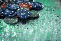 Poker playing chips on a green table and black background under the water drops. Online gambling. Addiction. Casino. Royalty Free Stock Photo