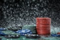 Poker playing chips on a green table and black background under the water drops. Online gambling. Royalty Free Stock Photo