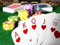 Poker royal flush hand and casino hands standing on poker table. 3D illustration Royalty Free Stock Photo