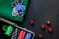 Poker set in a metallic case and green gambling cloth on a grey table top view copyspace