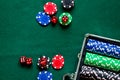 Poker set in a metallic case on a green gambling table top view copyspace
