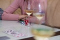 Poker table with chips, cards, glasses of champagne on the table with reflection. Enjoying the moment with friends