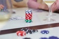 Poker table with chips, cards, glasses of champagne on the table with reflection. Enjoying the moment with friends