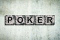 Poker, word on stone blocks, on a gray concrete wall. Poker. Gambling.