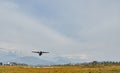 Pokhara, Nepal - April 13, 2019: An airplane of local Nepalese airlines flying against the mountain range of the Annapurna massif