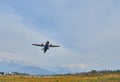 Pokhara, Nepal - April 13, 2019: An airplane of local Nepalese airlines flying against the mountain range of the