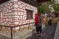 People touching the prayer bells of a temple in Pokhara on Nepal Royalty Free Stock Photo