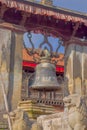 POKHARA, NEPAL - NOVEMBER 04, 2017: Close up of old rusted bell located in old structure in a temple in Pokhara, Nepal