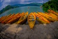 POKHARA, NEPAL - NOVEMBER 04, 2017: Close up of wooden yellow boats in a row at Begnas lake in Pokhara, Nepal, fish eye