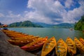 POKHARA, NEPAL - NOVEMBER 04, 2017: Close up of wooden yellow boats in a row at Begnas lake in Pokhara, Nepal, fish eye