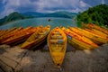 POKHARA, NEPAL - NOVEMBER 04, 2017: Close up of wooden yellow boats in a row at Begnas lake in Pokhara, Nepal, fish eye