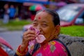 POKHARA, NEPAL - NOVEMBER 04, 2017: Portrait of old woman posing for camera in Pokhara, Nepal, in a blurred city