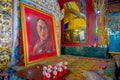 POKHARA, NEPAL - OCTOBER 06 2017: Indoor view of the sanctuary with some oblations and a portrait picture of Dalai Lama