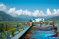 Pokhara, Nepal - October 2019: multi-colored wooden boats and catamarans near the pier on Phewa Feva Lake Royalty Free Stock Photo