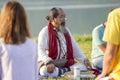 Tibetan Lama conducts classes with sunsurfers people on meditation and yoga near the lake, Pokhara, Nepal