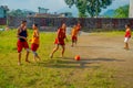 POKHARA, NEPAL - OCTOBER 06 2017: Unidentified Buddhist monk teenager playing soccer at the Sakya Tangyud monastery in