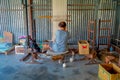 POKHARA, NEPAL - OCTOBER 06 2017: Unidentified woman working on loom manufacturing wool shawl clothing in Nepal