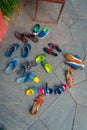 POKHARA, NEPAL - SEPTEMBER 04, 2017: Above view of asorted shoes over a stoned ground near of Tal Barahi Temple, located