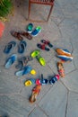 POKHARA, NEPAL - SEPTEMBER 04, 2017: Above view of asorted shoes over a stoned ground near of Tal Barahi Temple, located