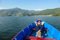 Pokhara - A woman lying in a boat, enjoying the surroundings Royalty Free Stock Photo