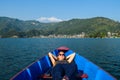 Pokhara - A woman lying in a boat, enjoying the surroundings Royalty Free Stock Photo